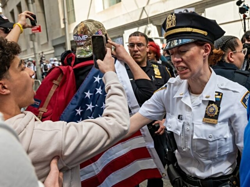 NEW YORK, NEW YORK - APRIL 15: Police watch as Pro Palestinian protesters and a group of I