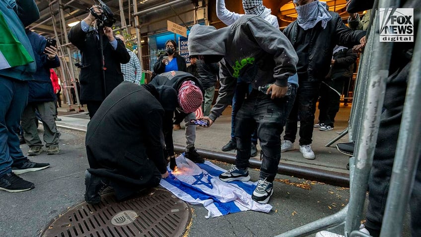 pro palestinian protesters light israel flag on fire in new york city trample flyers for hamas terror victims