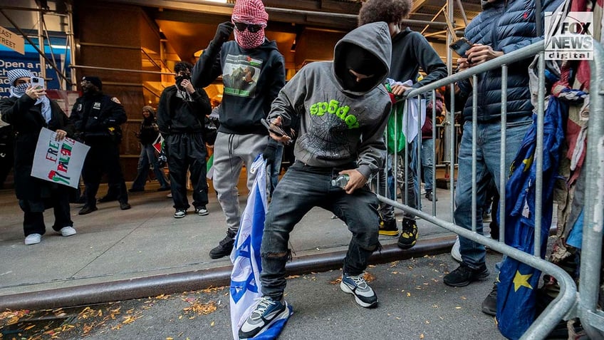 pro palestinian protesters light israel flag on fire in new york city trample flyers for hamas terror victims