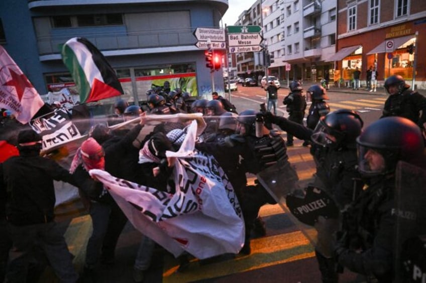 Anti-riot police officers used pepper spray to restrain activists during a demonstration a