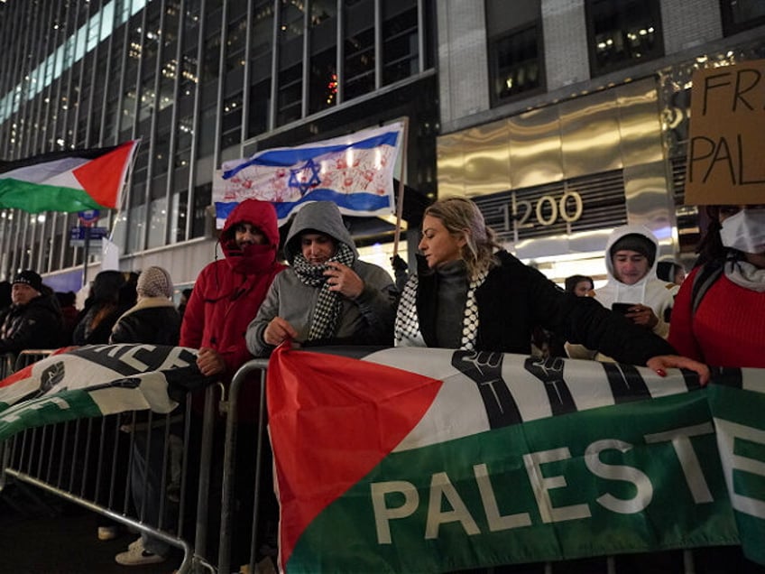 NEW YORK, NEW YORK - NOVEMBER 29: Pro-Palestine supporters gather for a rally at the Rockefeller tree lighting on November 29, 2023 in New York City. The rally comes as the initial four day truce between Israel and Hamas was extended by two days pausing the seven weeks of warfare …