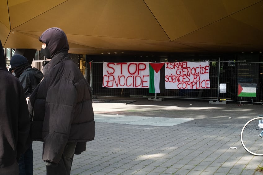 Banners and a Palestinian flag in front of the science po strasbourg school with the words "stop genocide" and "israel genocide, science po accomplice" in Strasbourg, France, 30 April 2024. Des banderoles et un drapeau palestinien devant l ecole de science po strasbourg avec ecrit "stop au genocide" et "israel genocide, science po complice" a Strasbourg, France, le 30 avril 2024. (Photo by Tobias Canales / Hans Lucas / Hans Lucas via AFP) (Photo by TOBIAS CANALES/Hans Lucas/AFP via Getty Images)