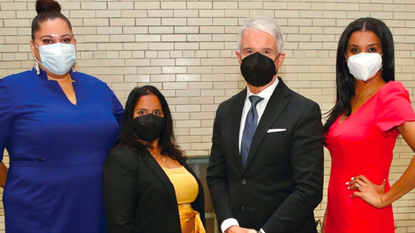 Alisa Blair, George Gascon and other special advisers pose for a photo in a hallway