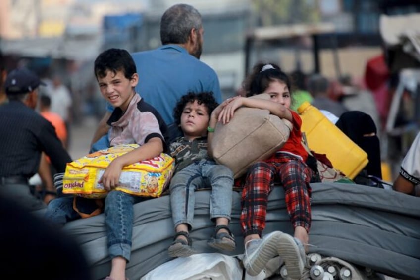 A Palestinian family flees Gaza's main southern city of Khan Yunis in response to an Israe