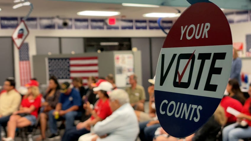 Decorations saying "your vote counts" hang from tent at Hispanic GOP voters event