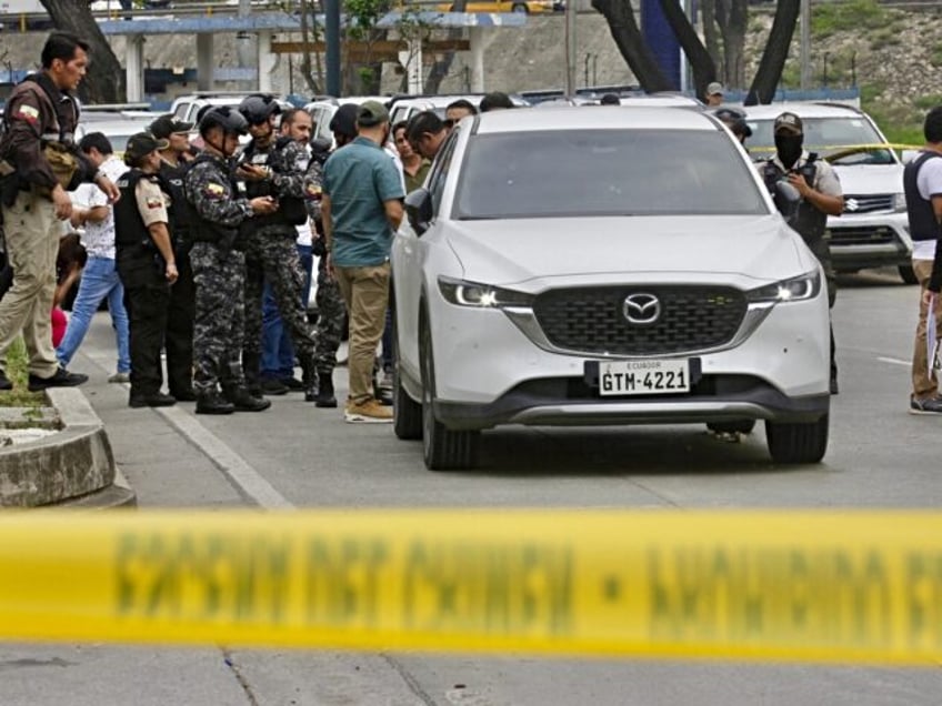 Members of the National Police remain in the place where Prosecutor Cesar Suarez was shot dead in Guayaquil, Ecuador on January 17, 2024. A prosecutor charged with investigating the dramatic live-broadcast armed assault last week on an Ecuadoran television station was shot dead Wednesday, the country's attorney general said. "In …