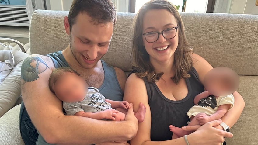 Leon and Savannah Katz holding their twin boys before one was allegedly killed by the family's friend.