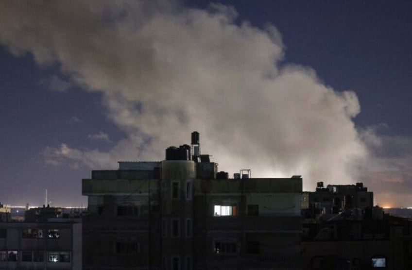 Smoke billows over buildings during Israeli bombardment in the Rafah area of the southern