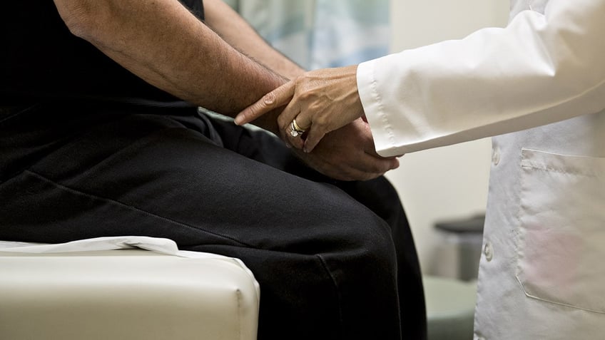 A medical doctor, right, examines a patient at a CCI Health and Wellness Services health center in Gaithersburg, Maryland, U.S., on Tuesday, April 18, 2017