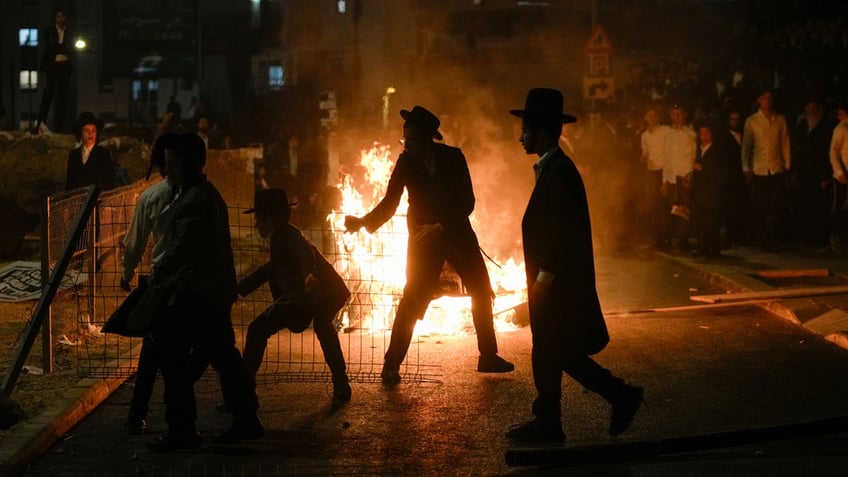 Ultra-Orthodox Jewish men protest against Israel's Supreme Court decision that ordered the government to begin drafting ultra-Orthodox men into the army.
