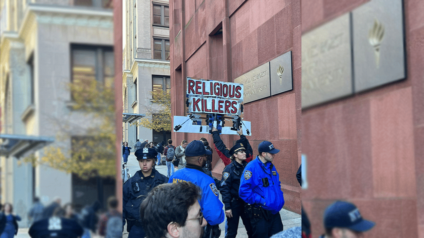 protester at nyu pro palestinian rally spits on jewish sign equates with white supremacy