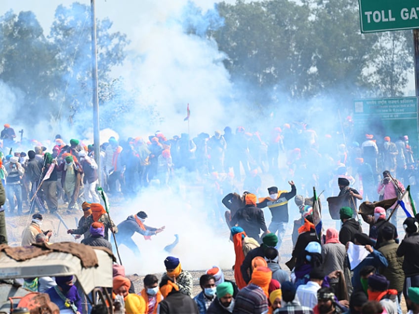 Haryana Police fired Tear gas shells to stop protesters to came near the barricades during the Farmers Protest at Shambu Border of Punjab and Haryana near Ambala, on February 14, 2024 in Chandigarh, India. Police deployed tear gas to halt thousands of farmers demanding minimum crop prices from advancing towards the capital New Delhi following unsuccessful negotiations with the government. Tear gas shells were fired and water sprayed from tankers on the protesting farmers who tried to cross the Shambhu border The police had even earlier in the day resorted to firing tear gas shells to disperse the agitating farmers who were approaching the police barricade. (Photo by Ravi Kumar/Hindustan Times via Getty Images)