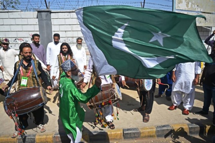 A fan waves Pakistan's national flag outside the National Stadium in Karachi