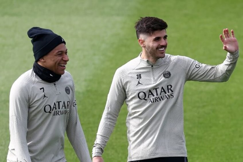 Kylian Mbappe (L) with teammate Lucas Beraldo on the eve of PSG's Champions League clash w