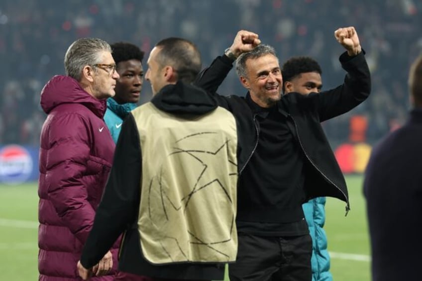 PSG coach Luis Enrique (R) celebrates his team's victory over Arsenal in Wednesday's Champ