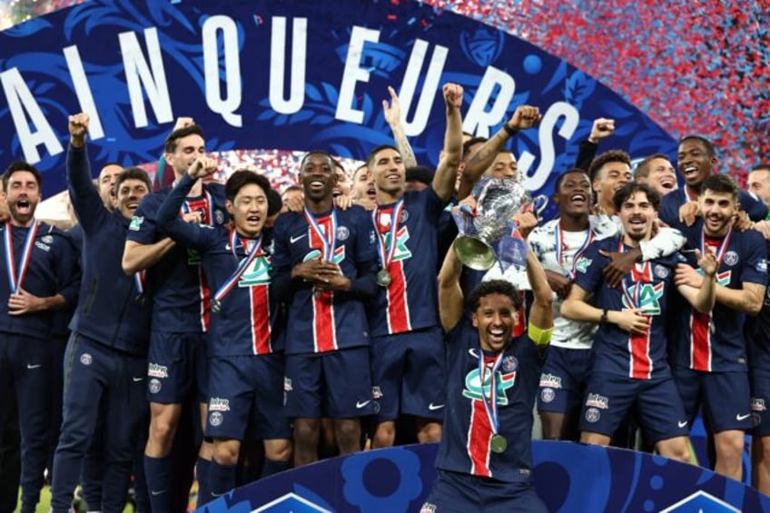 Paris Saint-Germain captain Marquinhos raises the French Cup aloft after his team's 3-0 wi