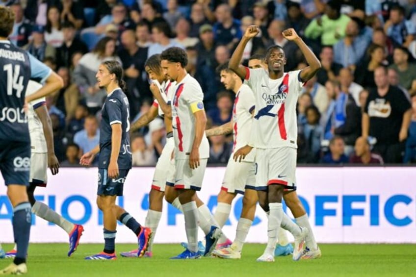 Ousmane Dembele (R) celebrates after scoring Paris Saint-Germain's second goal in their 4-