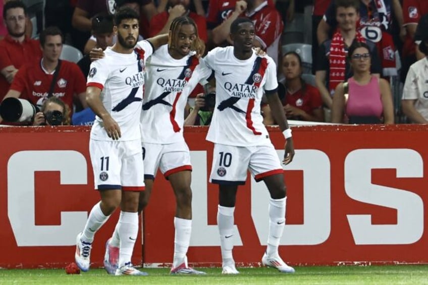 Bradley Barcola (C) celebrates with Marco Asensio and Ousmane Dembele after scoring Paris