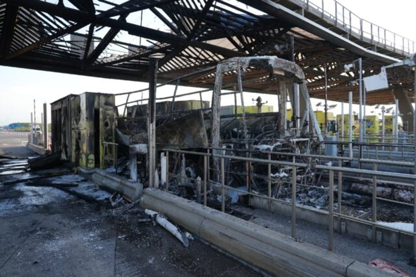 The charred remains of a bus after a clash occurred on the roadway between supporters of P