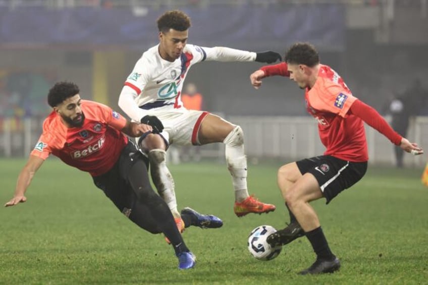 Paris Saint-Germain midfielder Desire Doue (centre) is squeezed by some fierce Espaly defe