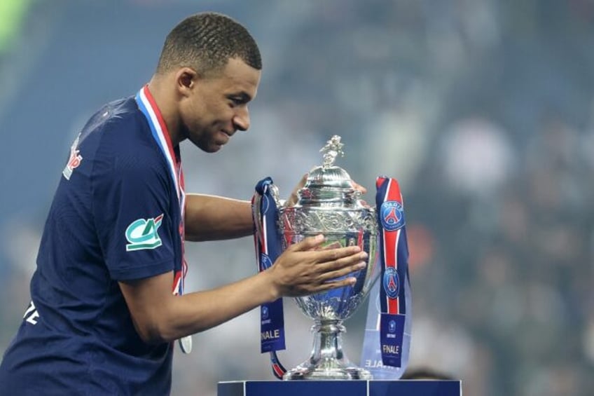 Kylian Mbappe with the trophy after PSG beat Lyon 2-1 in Saturday's French Cup final