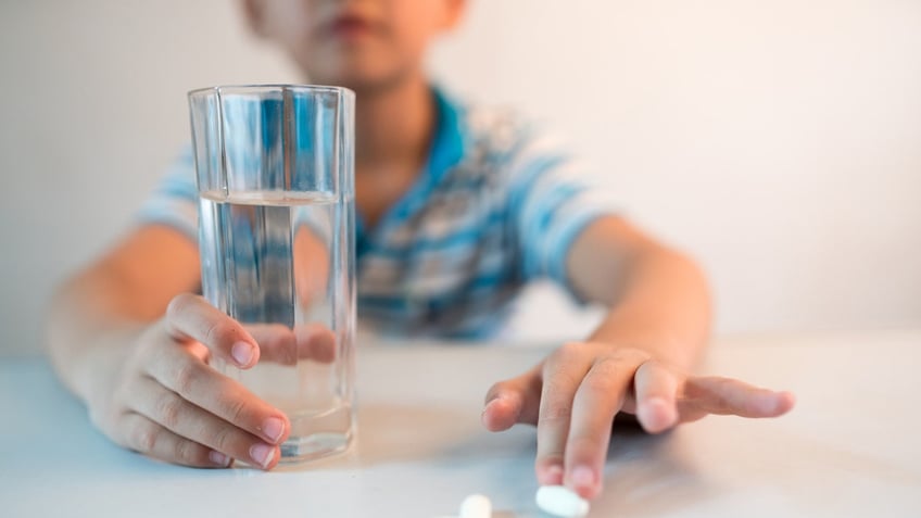 Boy taking pills