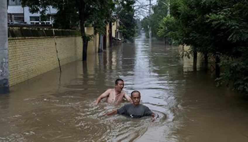 public anger grows after floodwaters deliberately diverted to save chinas capital