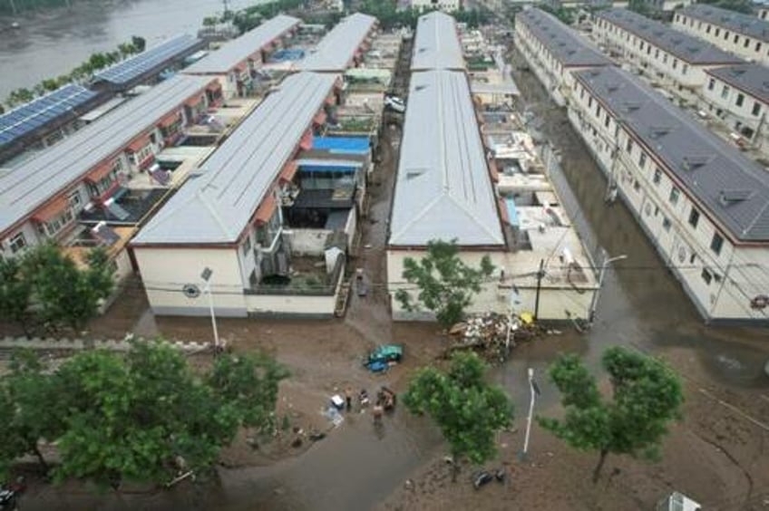 public anger grows after floodwaters deliberately diverted to save chinas capital