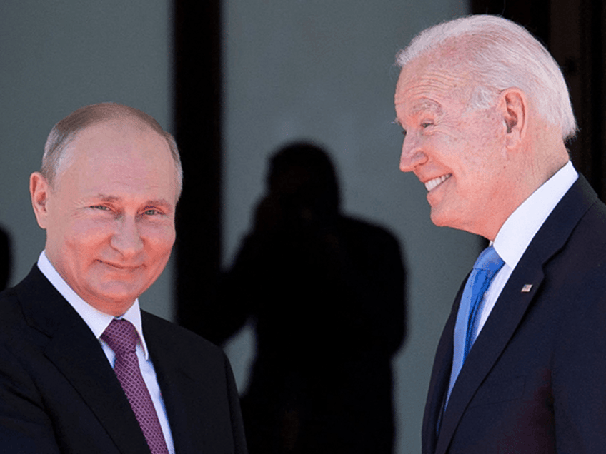 Russian President Vladimir Putin (L) shakes hands with US President Joe Biden prior to the US-Russia summit at the Villa La Grange, in Geneva on June 16, 2021. (Photo by Brendan Smialowski / AFP) (Photo by BRENDAN SMIALOWSKI/AFP via Getty Images)