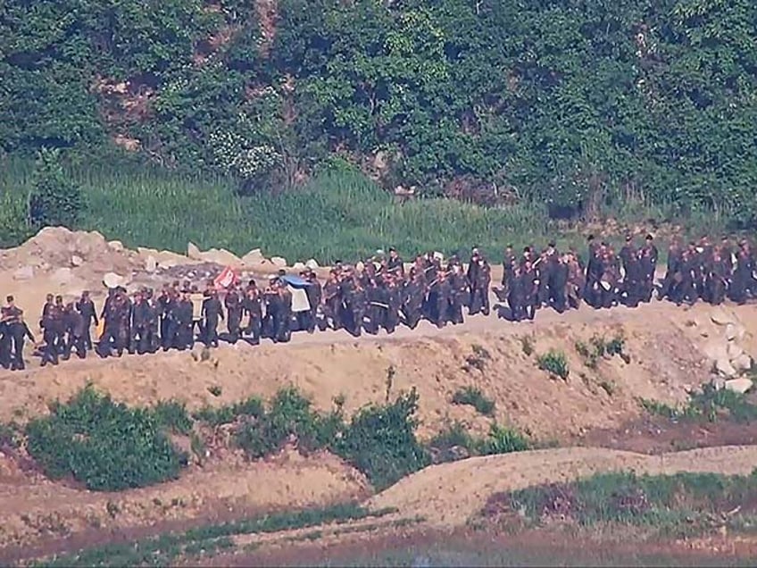 In this undated photo provided on Tuesday, June 18, 2024, by South Korea Defense Ministry, North Korean soldiers work at an undisclosed location near the border area, as seen from a South Korean guard area. South Korean soldiers fired warning shots to repel North Korean soldiers who temporarily crossed the rivals' land border Tuesday for the second time this month, South Korea's military said. (South Korea Defense Ministry via AP)