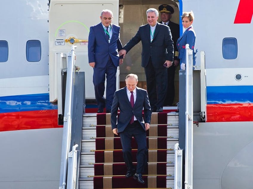 Russian President Vladimir Putin exits his plane on arrival at Mehrabad airport in Tehran, Iran, Wednesday, Nov. 1, 2017. Putin arrived in Iran for trilateral talks with Tehran and Azerbaijan. (AP Photo/Ebrahim Noroozi)