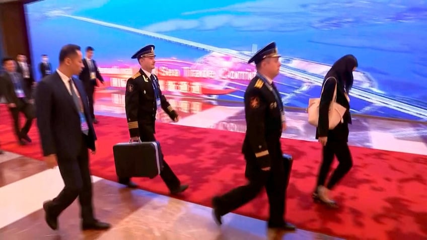 putin spotted in china with nuclear briefcase nearby in rare footage report