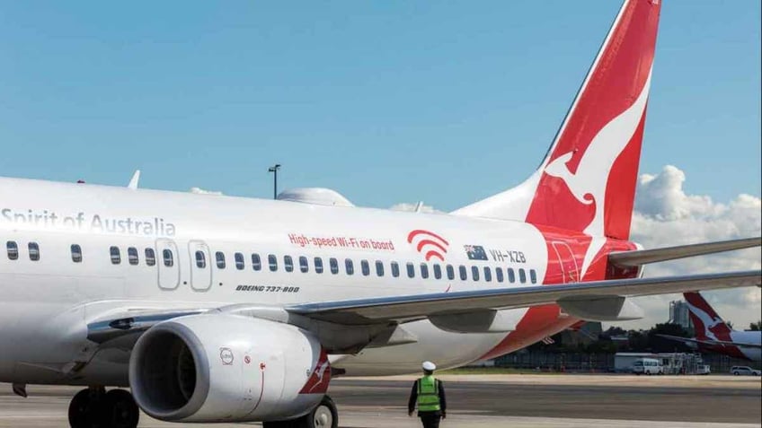 Qantas aircraft at a gate at an airport.