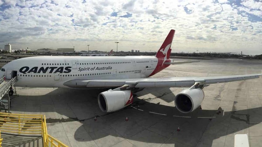 Qantas aircraft at a gate at the airport.