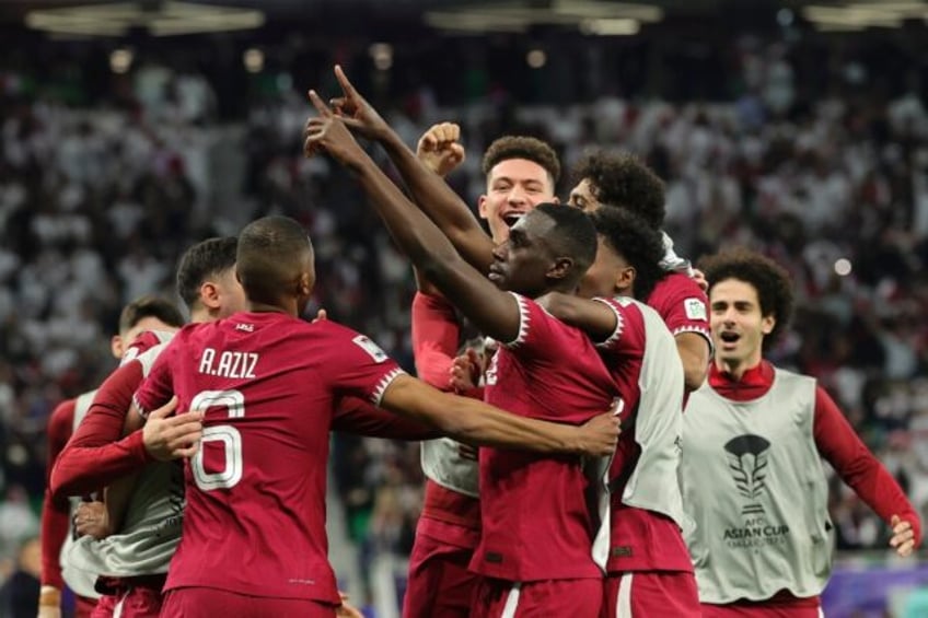 Almoez Ali (C) celebrates with his Qatar teammates after scoring the winner