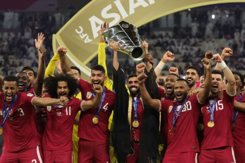 Hassan Al-Haydos lifts the Asian Cup for Qatar after the host nation beat Jordan in the fi