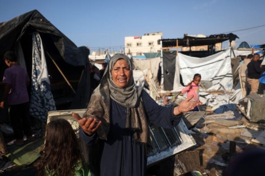 Displaced Palestinians in the aftermath of an Israeli strike that hit tents in the central