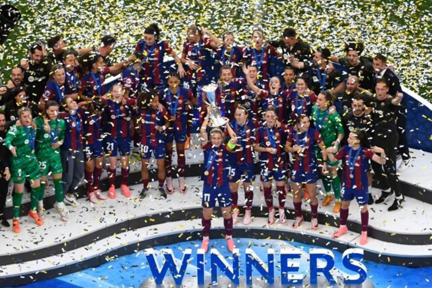 Alexia Putellas lifts the women's Champions League trophy after scoring in the 2-0 win ove