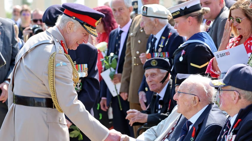 King Charles shakes hands with a veteran