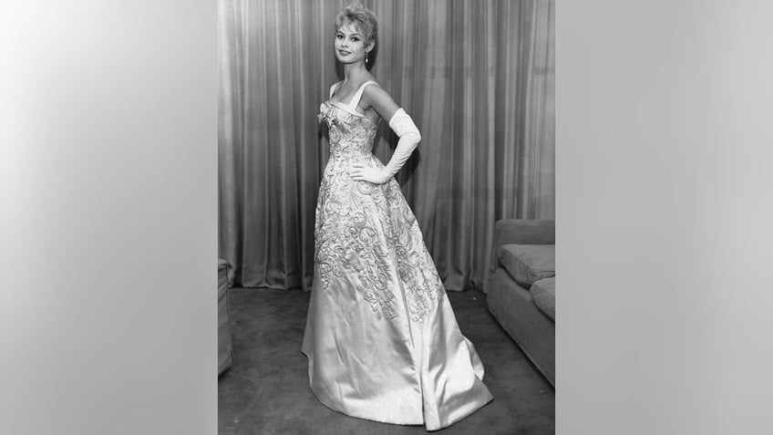 Brigitte Bardot posing in a glamorous gown.