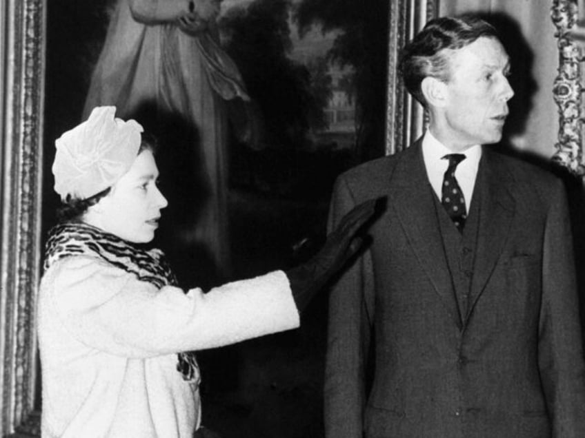 Queen Elizabeth II discusses some of the exhibits with Sir Anthony Blunt (extreme right),