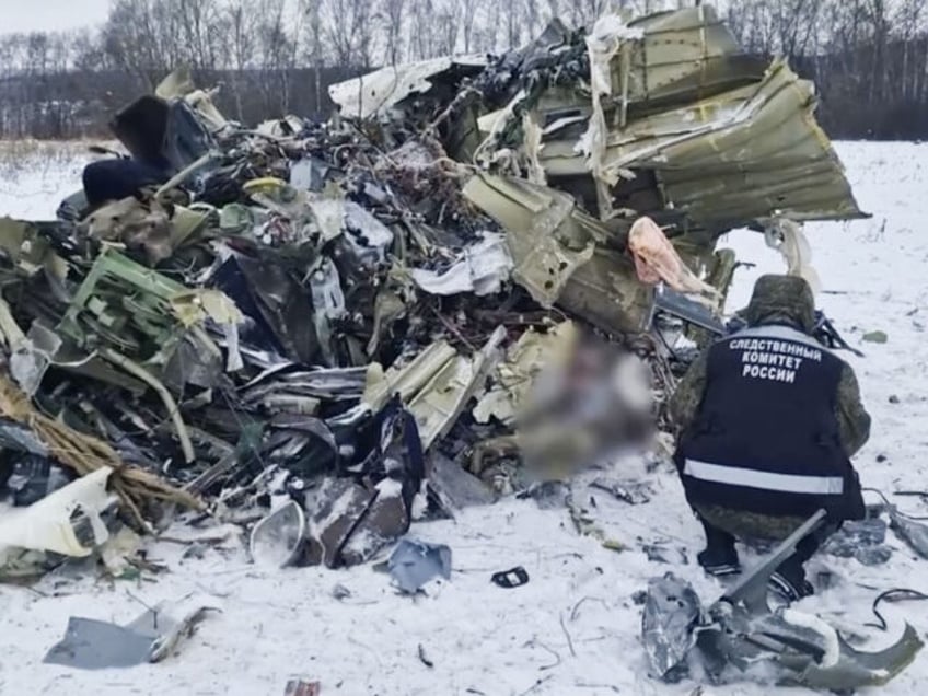 BELGOROD, RUSSIA - JANUARY 25: (----EDITORIAL USE ONLY MANDATORY CREDIT - 'RUSSIAN INVESTIGATIVE COMMITTEE / HANDOUT' - NO MARKETING NO ADVERTISING CAMPAIGNS - DISTRIBUTED AS A SERVICE TO CLIENTS----) A screen grab captured from a video shows officials inspect the site after the military transport plane that crashed in the …