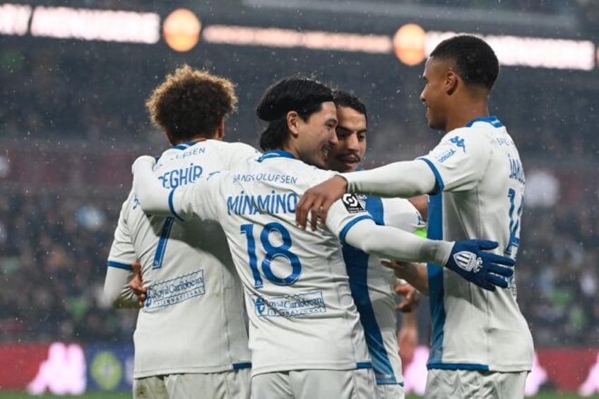 Takumi Minamino (C) celebrates with team-mates after opening the scoring for Monaco agains