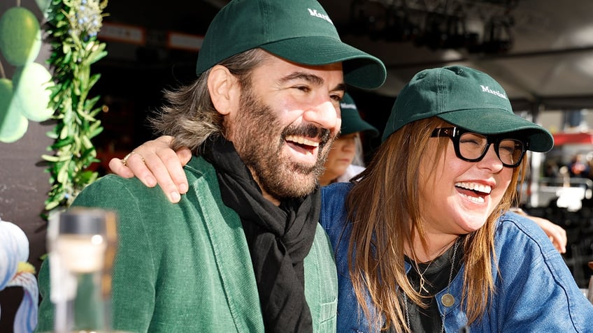 Rachael Ray wears glasses and a hat with husband John Cusimano.