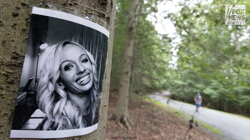 A photo of Rachel Morin is posted on a tree along a hiking route