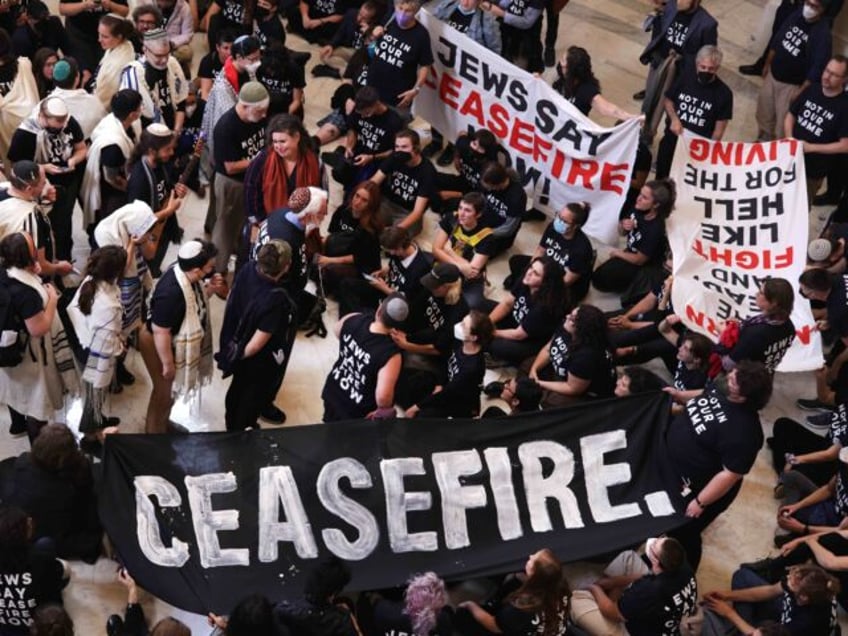 WASHINGTON, DC - OCTOBER 18: Protesters hold a demonstration in support of a cease fire ag