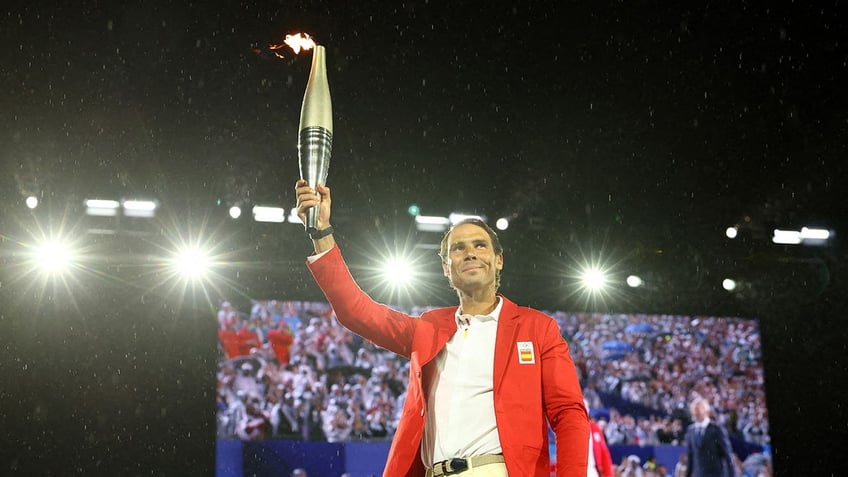 Rafael Nadal of Spain carries the Olympic torch