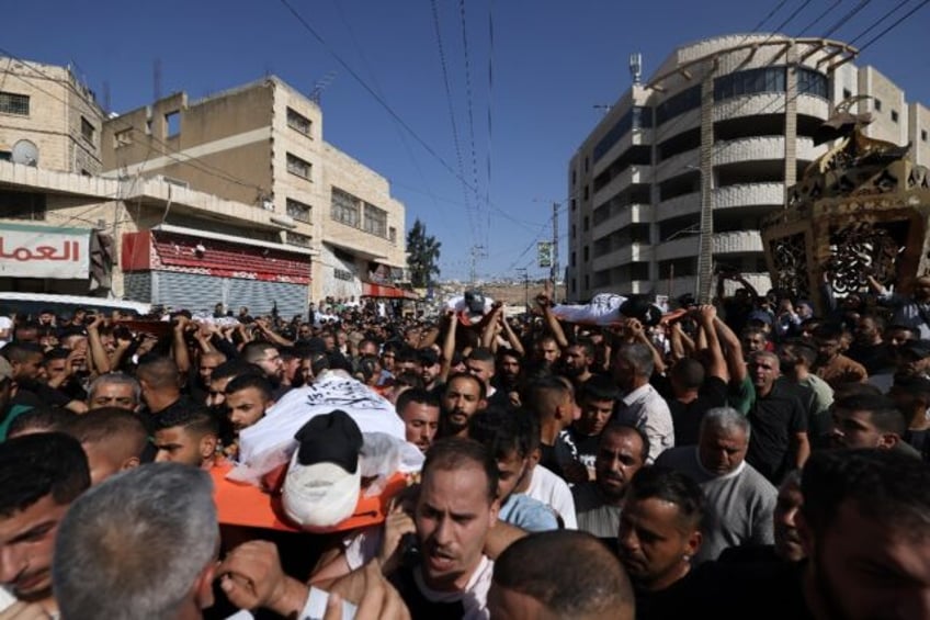 A large crowd gathered for the funeral procession of men killed in an Israeli air strike i