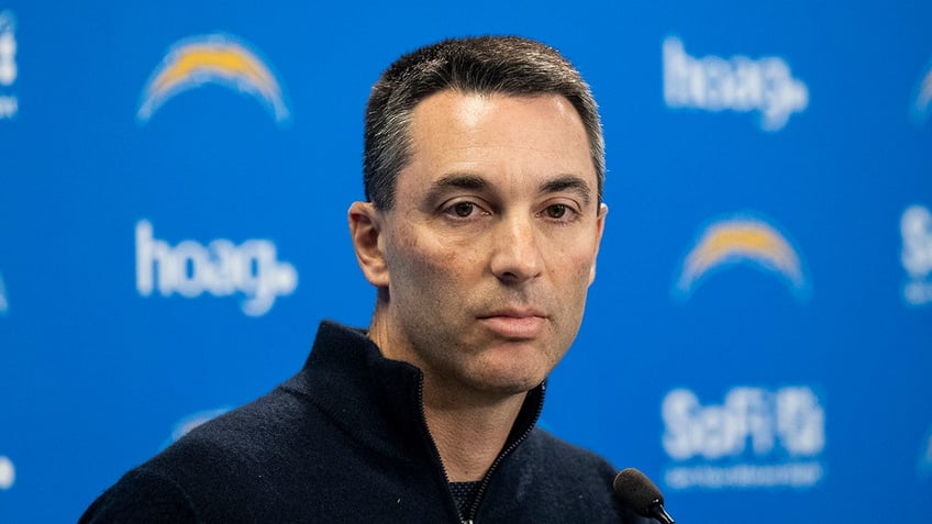 Tom Telesco looks on during media availability