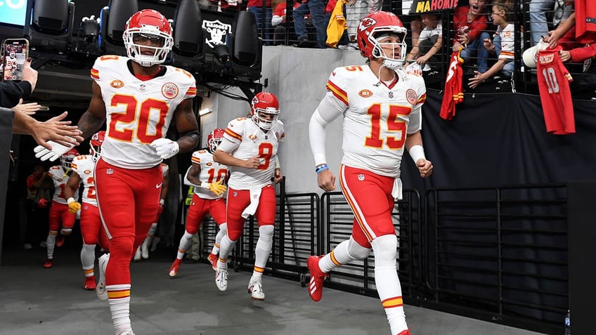 Patrick Mahomes and Justin Reid jog out of the tunnel